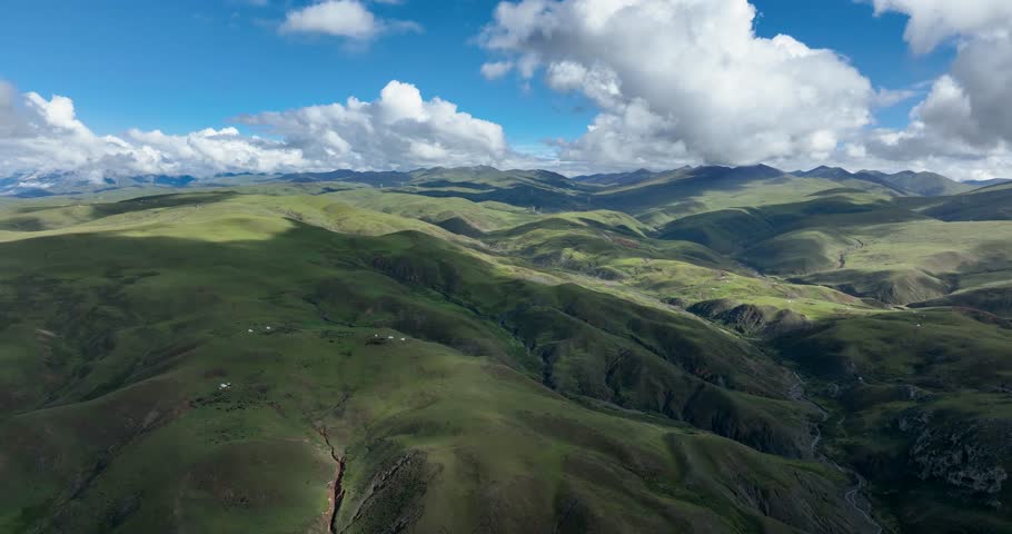 Beautiful green grassland and cloudy sky in Litang county, China
