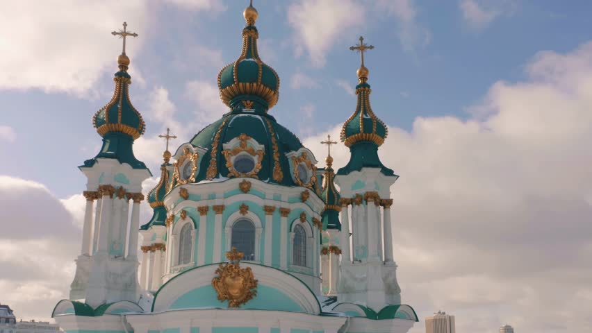 Beautiful Orthodox Church and Kyiv cityscape on a winter day. Aerial view from drone.