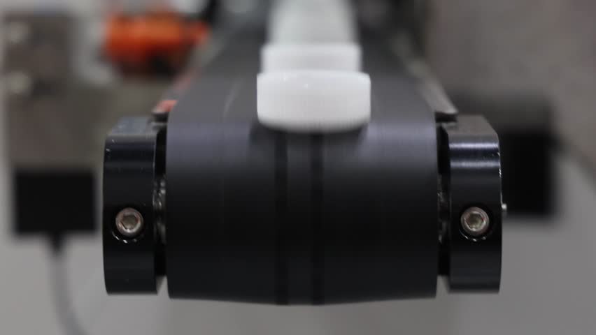 Caps making. Automated production line with industrial machines sorting and transporting plastic caps on a conveyor system. Manufacturing tech process for packaging pharmaceuticals or food industry.