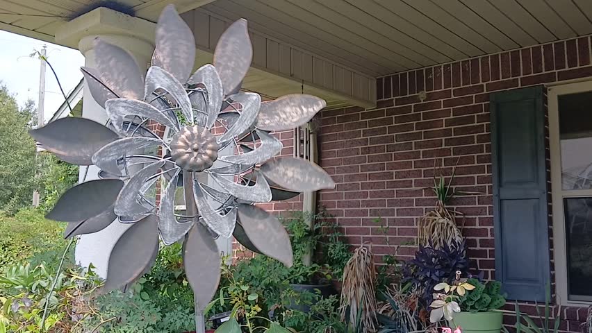 This flower design wind spinner made of metal is spinning beautifully as the wind keeps blowing.