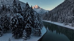 Breathtaking winter landscape with a majestic, snow-covered mountain peak illuminated by the golden light of sunrise (alpenglow). - Powered by Shutterstock - Get 15% off with code: PIKWIZARD15