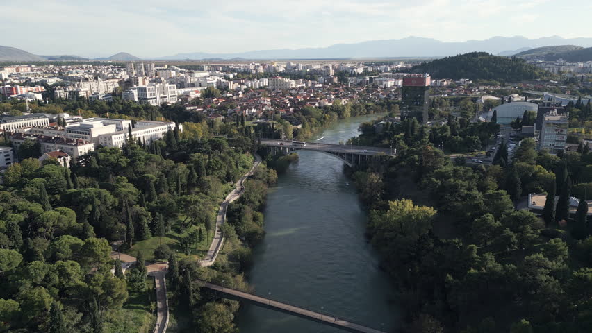 Aerial footage of Moraca river flowing through the city of Podgorica, the most populous city in Montenegro.
