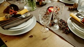 Elegant thanksgiving table setting with glasses, plates, and autumn decorations - Powered by Shutterstock - Get 15% off with code: PIKWIZARD15