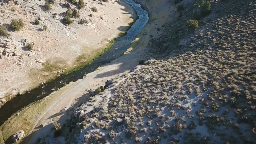 Aerial view of a river running through a canyon in a desert landscape