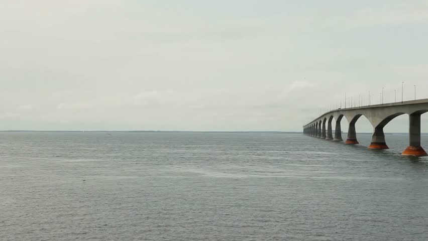 Confederation bridge stretching across the ocean on a cloudy day in canada