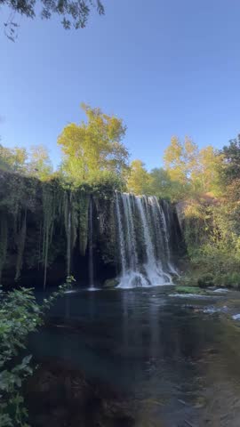 Nature scenery with a waterfall by summer