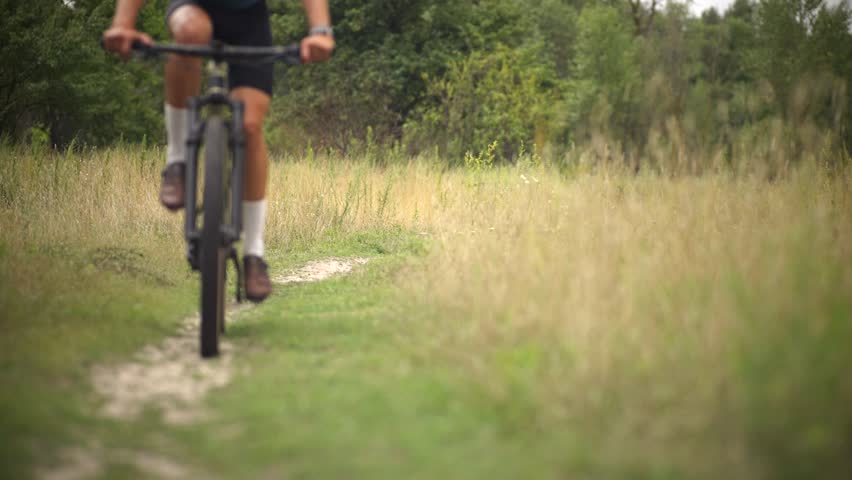 Mountain Biker Adventure Cycling. Cyclist Riding On Mountain Bike. Trail Ride Endurance Sport. Sportive Figure Fitness, Bike Helmet Protection. Cycling Apparel. Cyclist Off-Road Biking. Cycling Trip 