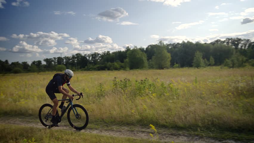 Mountain Biker Adventure Cycling. Cyclist Riding On Mountain Bike. Trail Ride Endurance Sport. Sportive Figure Fitness, Bike Helmet Protection. Cycling Apparel. Cyclist Off-Road Biking. Cycling Trip 