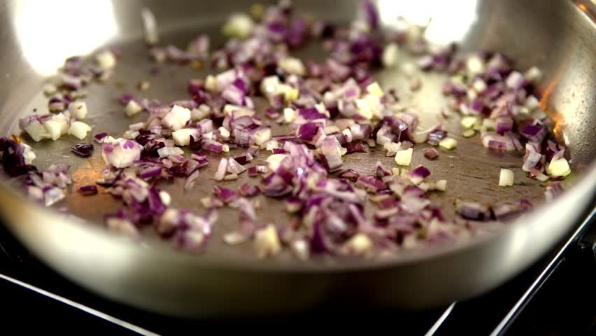 Diced Red Onions And Garlic Sauteing In Pan, Cooking Process. Home Cooking Preparation, Healthy Food Ingredients. Kitchen Activity, Food Preparation Meal Cooking. Organic Ingredients Home Kitchen
