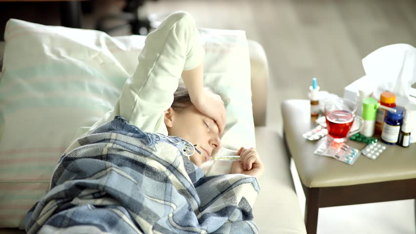 Sick Person Lying In Bed With Thermometer, Ill Female Touching Her Forehead, Feeling Unwell With Fever And Headache, Seasonal Sickness, Home Sickness, Viral Infection, Common Cold Symptoms Respiratory