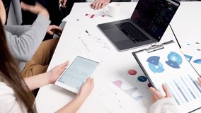 Teamwork with colleagues discussing reports and charts on a digital tablet during office meeting. - Powered by Shutterstock - Get 15% off with code: PIKWIZARD15