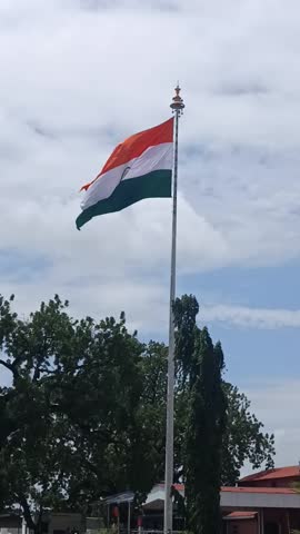 Indian Tiranga soaring high in the wind, its saffron, white, and green colors shining bright, reflecting the spirit of independence and unity.