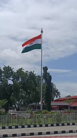The Indian Tiranga flag gracefully flying in the air, symbol of freedom, unity, and national pride, waving high against the open sky.