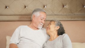Happy Asian family senior couple relaxing together on the bed. Portrait of Elderly husband and wife hugging and taking care each other. Retired old people mental healthcare and family relationship. - Powered by Shutterstock - Get 15% off with code: PIKWIZARD15