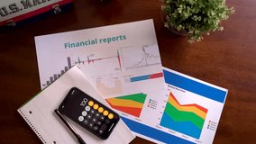Calculator and financial report papers with graphs and colorful charts for analysis. - Powered by Shutterstock - Get 15% off with code: PIKWIZARD15