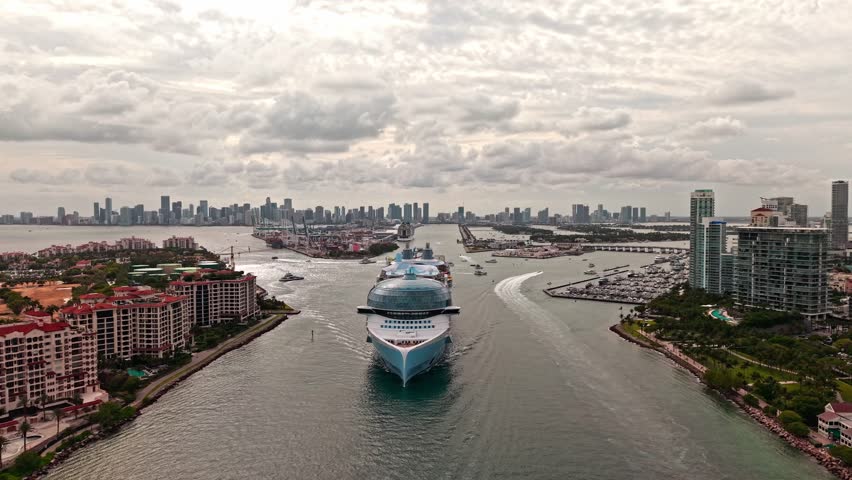 Aerial view of luxury liner voyage. Ship leaving Miami beach port. Miami tour. Cruise ship voyage. Aerial view of cruise in summer vacation. Cruise ship tour and travel at sea. Luxury cruise voyage