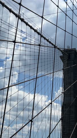 View of the sky through a large automobile bridge with many metal frames. 