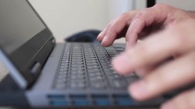 Close-up of hands using a laptop keyboard and mouse on a wooden desk. Work, internet browsing, and technology concept in modern everyday life. - Powered by Shutterstock - Get 15% off with code: PIKWIZARD15