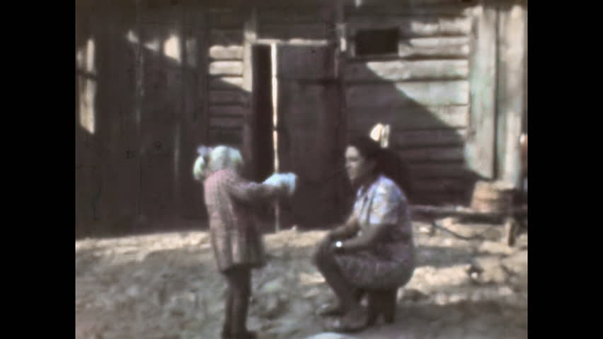 Old archive, Child girl enjoy play with pet on rural summer street. Mother fun in natural bond with animals. Rural family in natural outdoors. Carefree outdoor leisure. Vintage film. Archival retro