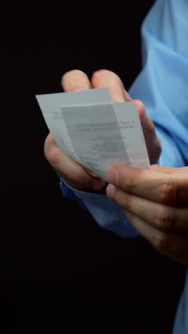 paper receipt in the hands of a businessman in close-up.
Bill after shopping.
Financial report in the bank and receipt of expenses.
Paperwork in the bank.
Online shopping and money