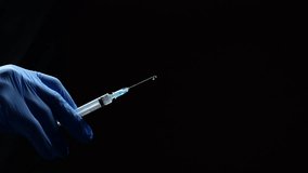 Syringe with medicine in hands of doctors in blue latex gloves.
Doctor with injection syringe in hands on black background.
Prevention from illness and viruses.
Concept of medicine - Powered by Shutterstock - Get 15% off with code: PIKWIZARD15