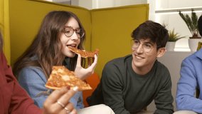 Young professionals sharing pizza, laughing and bonding during relaxed break in bright, modern workplace with vibrant team atmosphere - Powered by Shutterstock - Get 15% off with code: PIKWIZARD15