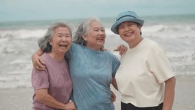 Happy Asian Senior Women Friends Smiling at the Camera During a Calm and Joyful Retirement Vacation on the Beach - Powered by Shutterstock - Get 15% off with code: PIKWIZARD15