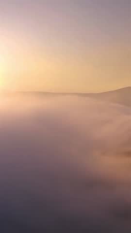 Misty Nature at Sunrise Above Dreamy Clouds, Aerial View, Vertical Video