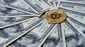 Cryptocurrency And Cash Together Shiny Bitcoins Rotate On American Dollar Bill. Conceptual Footage For Financial Technology, Investment, Blockchain Economy, And Modern Online Exchange Systems. - Powered by Shutterstock - Get 15% off with code: PIKWIZARD15