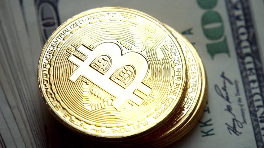 Macro Footage Of Gold Bitcoin Coins Lying On Hundred Dollar Bills, Representing The Merge Of Classic Economy And Future Financial Technologies In A Secure Digital World.