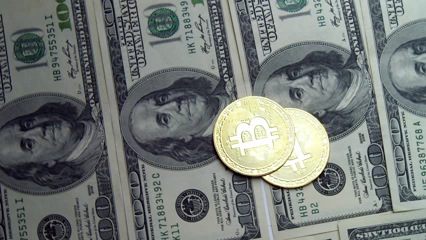 Cryptocurrency Wealth On Dollar Shiny Bitcoin Coins Positioned Over Hundred Dollar Bills. Dynamic Rotating Shot Reflects Financial Planning, Crypto Mining Profits, And Future Of Electronic Payments.