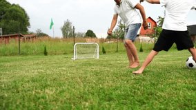 Grandfather and grandson playing football in the yard of the house on the lawn - Powered by Shutterstock - Get 15% off with code: PIKWIZARD15