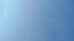 A person refuses to drink alcohol, pouring wine out of a glass on a clear glass background with a blue sky in the background. Low angle. Slow motion. - Powered by Shutterstock - Get 15% off with code: PIKWIZARD15