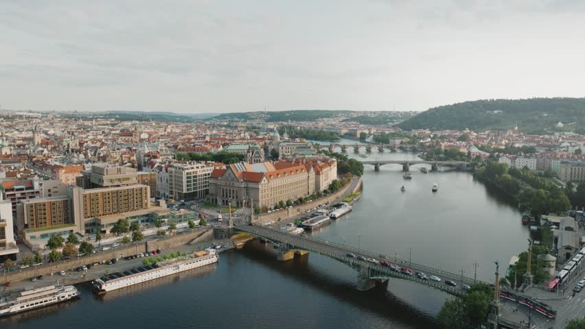 Aerial view over Prague rivers, Czech Republic, with historic old town and Prague Astronomical Clock in background, panoramic cityscape from drone