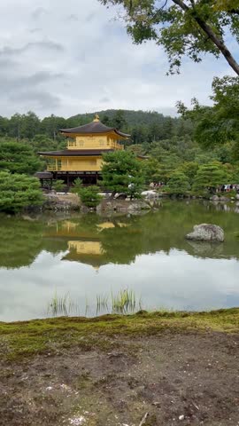 The Golden Pavilion (Kinkakuji Temple) is reflected in the calm water of the pond.Kyoto, Japan.