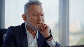 Frowned leader looking decisions financial problems at light workspace closeup. Tensed senior businessman thinking on corporate troubles in office. Thoughtful manager planning problem-solving strategy - Powered by Shutterstock - Get 15% off with code: PIKWIZARD15