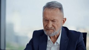Stressed financier reading report at company business office closeup. Frustrated elderly businessman closing laptop worried financial disaster. Unhappy manager feeling despair of corporate failure. - Powered by Shutterstock - Get 15% off with code: PIKWIZARD15