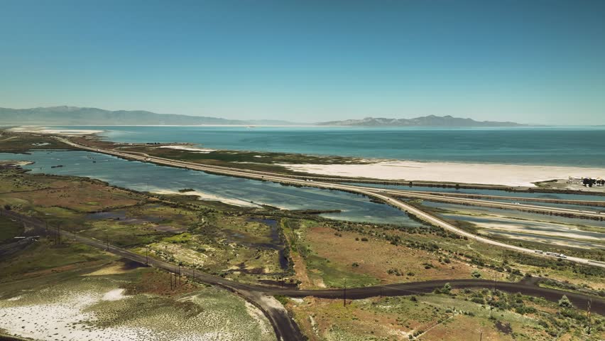 Aerial drone view of Great Salt Lake with mountains, nature and roads, Utah, USA