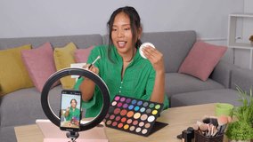 Confident beauty influencer recording makeup product review during engaging livestream from personalized home studio, showcasing latest cosmetic trends - Powered by Shutterstock - Get 15% off with code: PIKWIZARD15