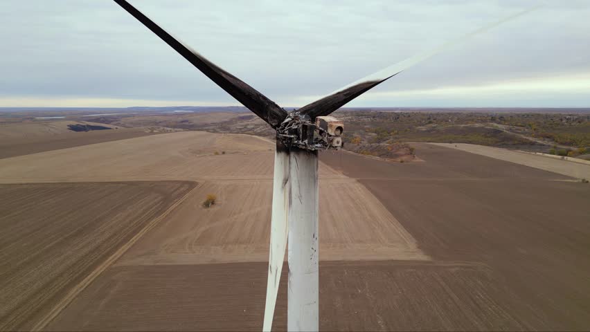 Close up footage of a burned down wind turbine generator. Lightning strike of windmill or overheating caused meltdown of power generator engine and mechanical system. Destroyed infrastructure Disaster
