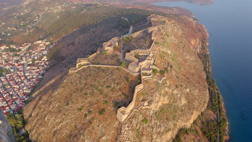 4k drone forward video (Ultra High Definition) of  fortress of Palamidi. Stunning evening view of Peloponnese peninsula, Greece, Europe. Aerial cityscape of Nafplion town.