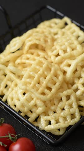 Lattice or wafer potato chips, crispy yellow snacks, takeaway food. Potato chips, junk food