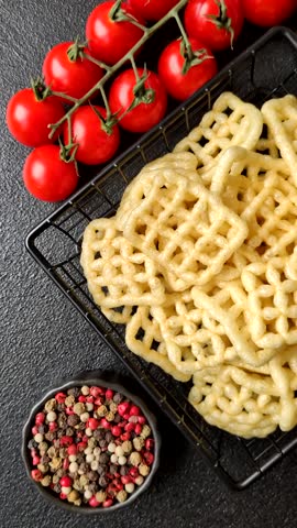 Lattice or wafer potato chips, crispy yellow snacks, takeaway food. Potato chips, junk food
