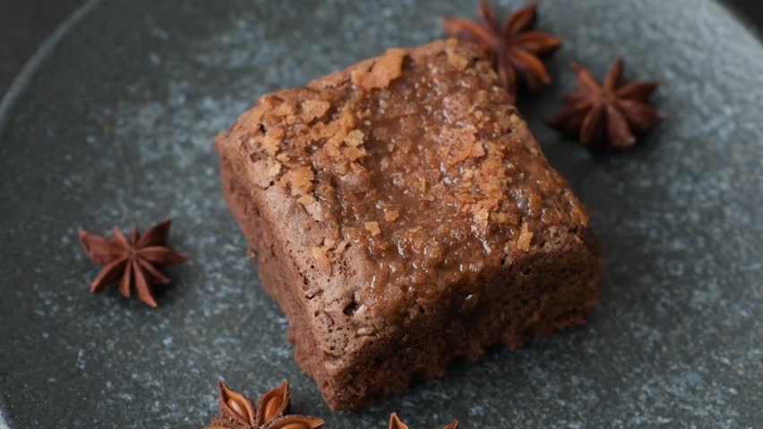 Chocolate brownie cake, food, sweet dessert with nuts rectangular shape. A slice of sweet chocolate brownie for the dinner table