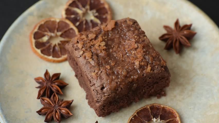 Chocolate brownie cake, food, sweet dessert with nuts rectangular shape. A slice of sweet chocolate brownie for the dinner table