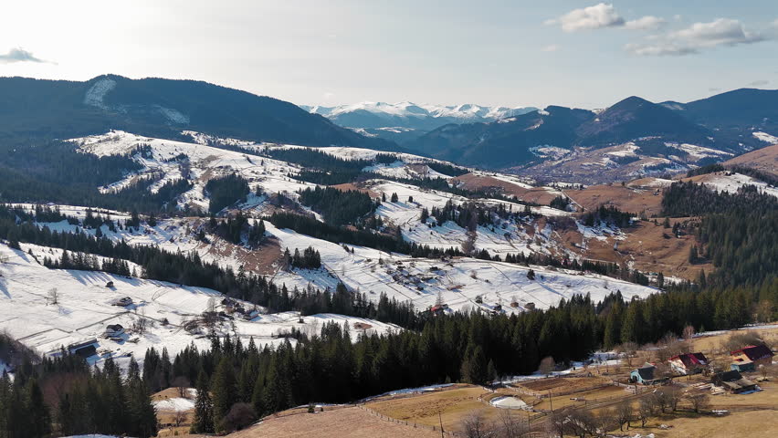 Carpathian Mountains Aerial Panorama With Snow Covered Hills Forest Valleys And Rural Villages Under Clear Sky, scenic winter landscape of Ukrainian highlands and natural beauty