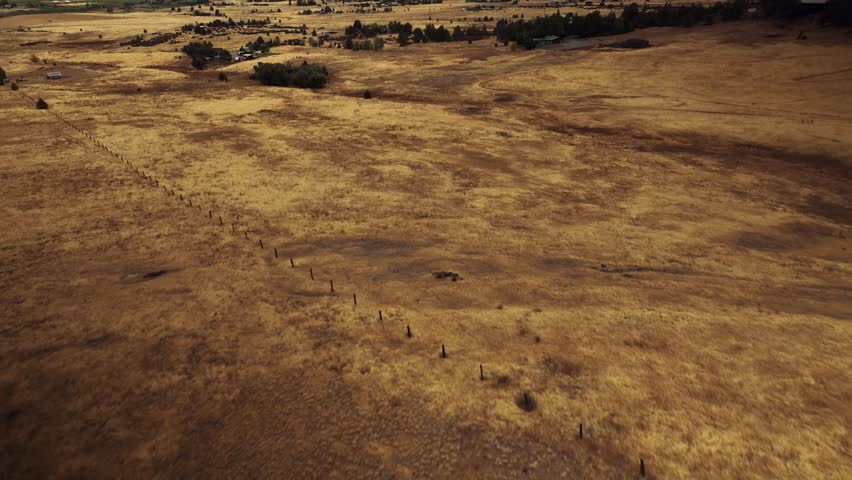 Aerial drone view of California mountains and plains with small settlements