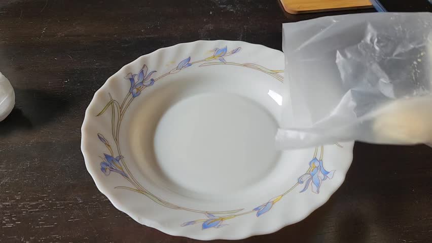 Preparing Traditional Rice Dish with Hard Boiled Egg on a Decorative Plate