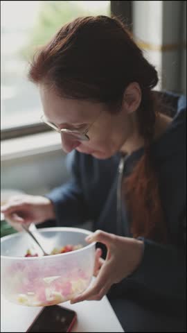 Woman enjoying a healthy salad at home