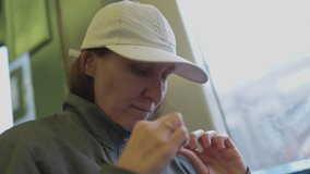 Woman filing nails on public transport - Powered by Shutterstock - Get 15% off with code: PIKWIZARD15